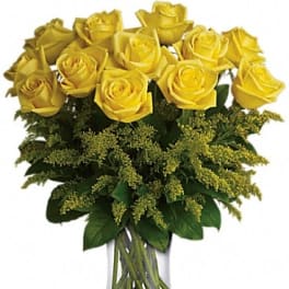Yellow roses arranged in a clear glass vase