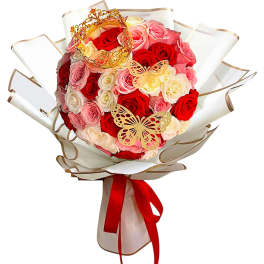 Bouquet of red, pink, and white roses with butterfly decorations and a red ribbon