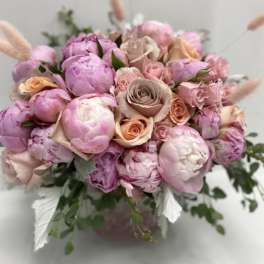 Pink and peach bouquet of peonies and roses in a vase