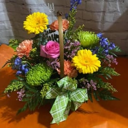 Colorful floral basket with gerbera daisies, roses, and a green plaid bow