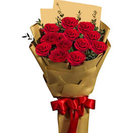 Bouquet of red roses wrapped in gold paper with a red ribbon