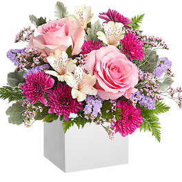 Pink roses and magenta mums in a white box vase