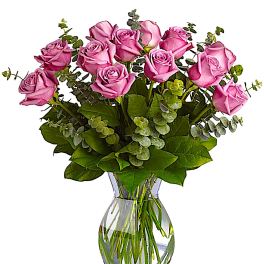 Pink roses arranged in a clear glass vase