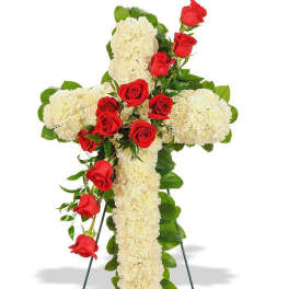 Cross-shaped floral tribute with red roses and white carnations