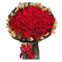 Large bouquet of red roses with gold-toned leaves and a red ribbon