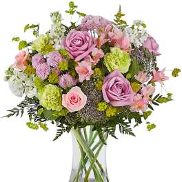Pink and lavender mixed bouquet in a clear glass vase