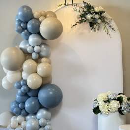 Blue and cream balloon arch with white floral accents