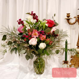 Mixed pink and white flower arrangement in a glass vase