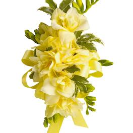 Yellow floral corsage with ribbon and green accents