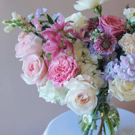 Mixed pink and white flower bouquet in a clear glass vase