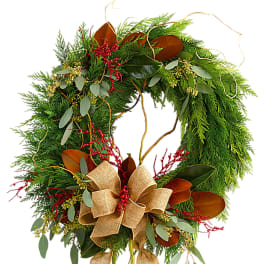 Evergreen wreath with red berries and a burlap bow
