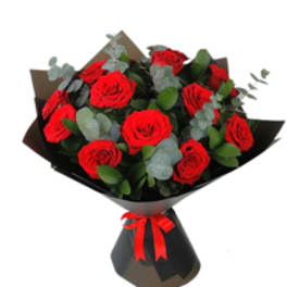Bouquet of red roses wrapped in black paper with a red ribbon