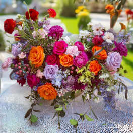 Colorful mixed bouquet of roses and other flowers on a table