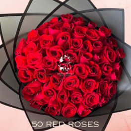 Bouquet of red roses wrapped in black paper