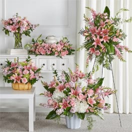 Pink lily and rose floral arrangements in vases and containers