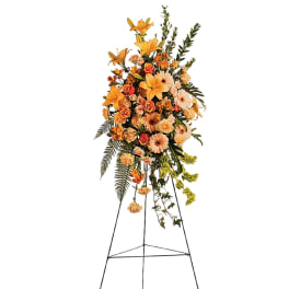 Tall orange floral spray on a metal easel