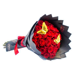 Bouquet of red roses wrapped in black paper with gold butterfly accents