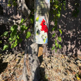 Hanging memorial wind chime with a cardinal and white flowers