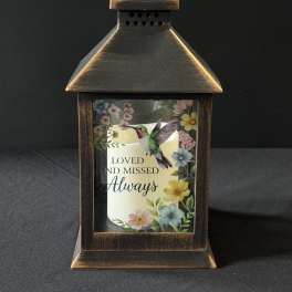 Decorative lantern with a memorial candle and floral print