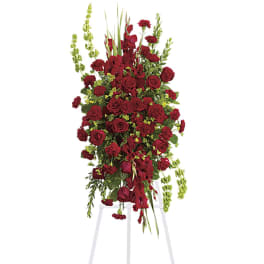 Tall red floral spray on a white easel
