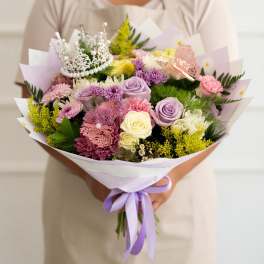 Handheld bouquet of pastel roses, chrysanthemums, and a silver tiara