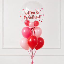Balloon bouquet with a clear balloon reading "Will You Be My Girlfriend?"
