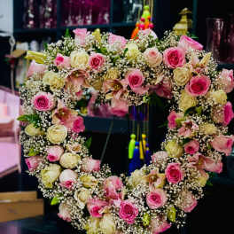 Heart-shaped floral wreath with pink and cream roses