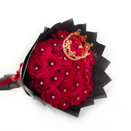 Bouquet of red roses wrapped in black paper with a gold crown
