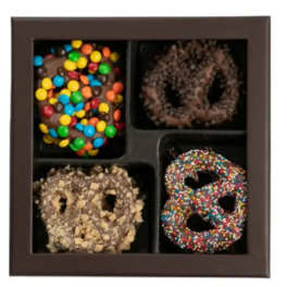 Box of four chocolate-covered pretzels with assorted toppings