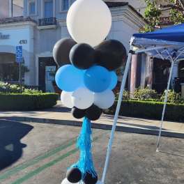 Tall balloon column in black, white, and blue with a blue tassel