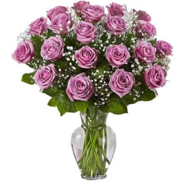 Lavender rose bouquet with baby's breath in a clear glass vase