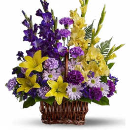 Purple and yellow floral basket arrangement with daisies and lilies