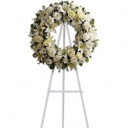 White floral wreath on a standing easel