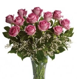 Pink roses arranged in a clear glass vase