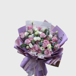 Bouquet of pink and white roses wrapped in lavender paper