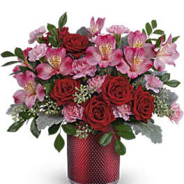 Red roses and pink alstroemeria in a red vase