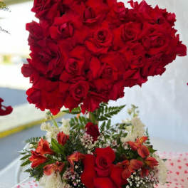 Heart-shaped red rose arrangement above a mixed red and white floral bouquet