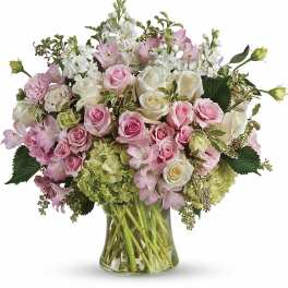 Pink and white roses with alstroemeria in a glass vase