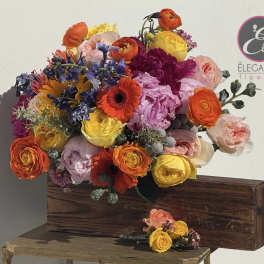 Bright mixed bouquet in a wooden box with a matching boutonniere