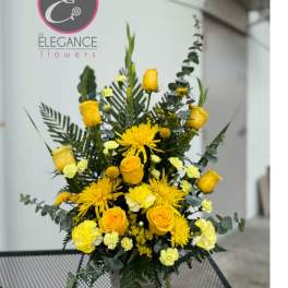 Yellow roses and chrysanthemums arranged in a vase