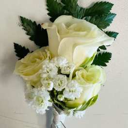 White rose and calla lily bouquet with small white filler flowers