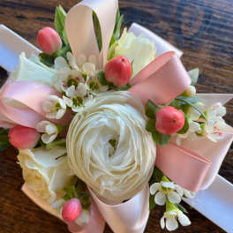 Small bouquet of white flowers with pink ribbon and pink berry accents