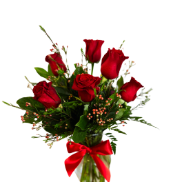 Red roses in a glass vase with a red ribbon