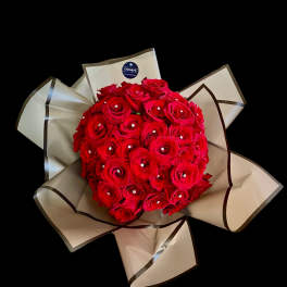 Bouquet of red roses wrapped in beige paper