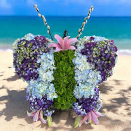 Butterfly-shaped floral arrangement with hydrangeas and pink lilies