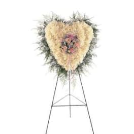Heart-shaped floral standing spray on an easel