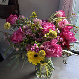 Pink and yellow mixed bouquet in a clear glass vase