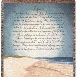 A woven blanket with a beach scene and printed poem text