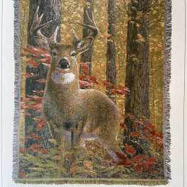 Fringed wall hanging with a deer in an autumn forest scene