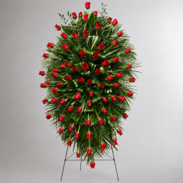 Standing spray of red roses on a metal easel